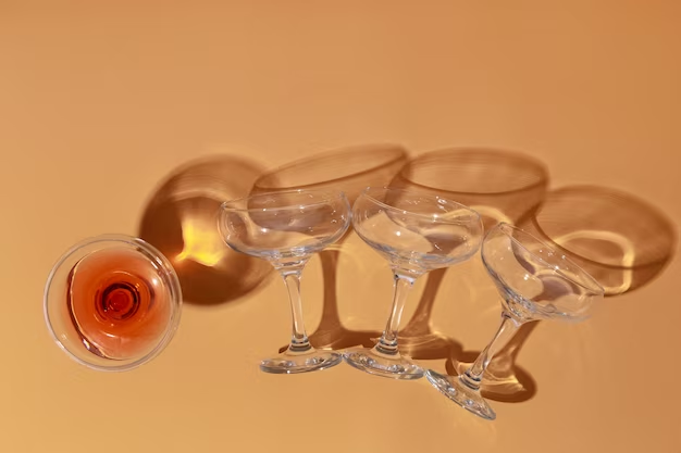 Top-down view of 3 empty wine glasses and 1 wine-filled glass