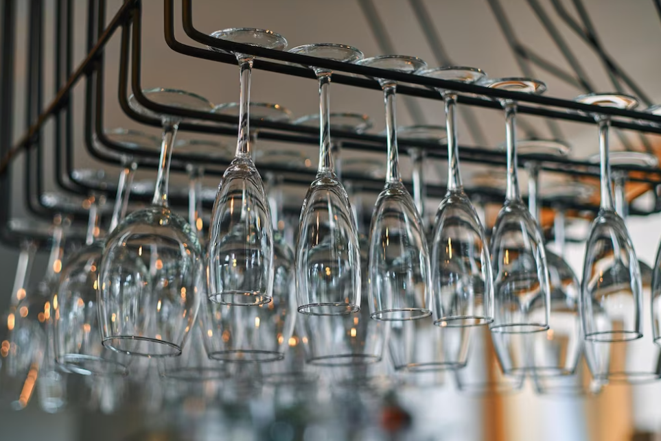 wine glasses hanging in the bar above the bar counter